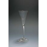 A fine mixed twist flute or toasting glass, c.1750, the narrow drawn trumpet bowl rising from a