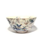 A large Delft punch bowl, c.1710, the exterior painted with exotic birds amongst flowers, bamboo and