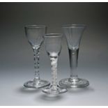 Three small wine glasses, c.1740-60, one of Lynn type and moulded with horizontal ribs over an