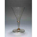 A small façon de Venise wine glass, late 17th century, with deep funnel bowl raised on a hollow stem