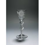 A small wine glass of Jacobite significance, c.1760, the round funnel bowl engraved with a rose