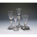 Four various glasses, c.1750-70, including a wine with a bell bowl raised on a multi-knopped stem, a
