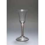 A colour twist wine glass, c.1770, the bell bowl raised on a stem enclosing green, red and white