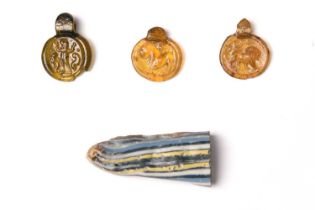 Three Roman glass pendants circa 4th - 5th century AD each stamped with a differing image and with a