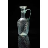 A Byzantine pale green glass hexagonal jug circa 6th - 7th century AD mould-blown with the panels