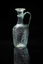 A Byzantine pale green glass hexagonal jug circa 6th - 7th century AD mould-blown with the panels