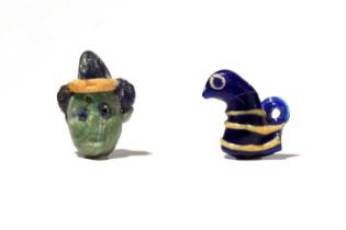 A Phoenician glass head pendant Eastern Mediterranean, circa 600 - 200 BC the green face with