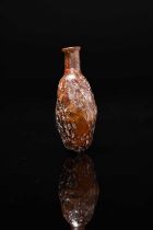 A Roman amber glass date flask circa 1st - 2nd century AD mould blown with a cylindrical neck and