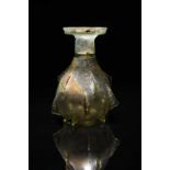 A Roman pale green glass sprinkler flask circa 2nd - 3rd century AD the pear shape body with fifteen