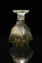 A Roman pale green glass sprinkler flask circa 2nd - 3rd century AD the pear shape body with fifteen