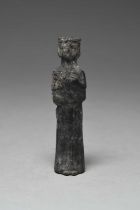 An Assyrian bronze kohl vessel circa 1st Millenium BC as a standing robed woman with her left hand