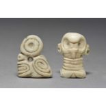 Two Taino amulets Dominican Republic, circa 1100 - 1500 AD shell, one carved as a skeletal head with