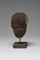 An Egyptian wood head Late Period - Ptolemaic Period, circa 664 - 30 BC with the remains of the