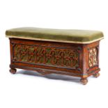 A VICTORIAN WALNUT OTTOMAN STOOL C.1870-80 with ebonised decoration and with pierced fretwork