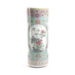 A CHINESE PORCELAIN FAMILLE ROSE CYLINDRICAL STICKSTAND C.1900 painted with floral cartouches on a