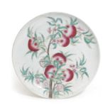 A CHINESE PORCELAIN PEACH CHARGER 19TH CENTURY decorated in the famille rose palette with a fruiting
