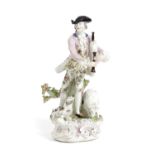 A BOW PORCELAIN FIGURE OF A MAN PLAYING BAGPIPES C.1750-60 modelled standing before a tree stump,