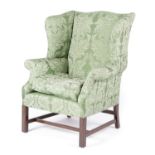 A MAHOGANY WING ARMCHAIR IN GEORGE III STYLE, EARLY 20TH CENTURY later upholstered with green