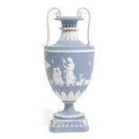 A WEDGWOOD BLUE AND WHITE JASPER VASE 19TH CENTURY of urn form, with a continuous scene of women,