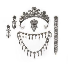 A suite of cut steel jewels, 19th century, comprising: a tiara of floral design, inner curve 21.5cm,