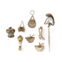 A group of seven charms and a stick pin, 19th century, comprising: five mother of pearl charms
