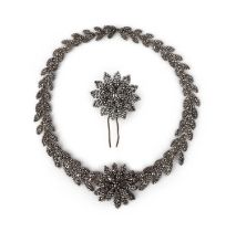 A cut steel demi-parure, 19th century, comprising: a necklace, centring on a flower, to a necklace