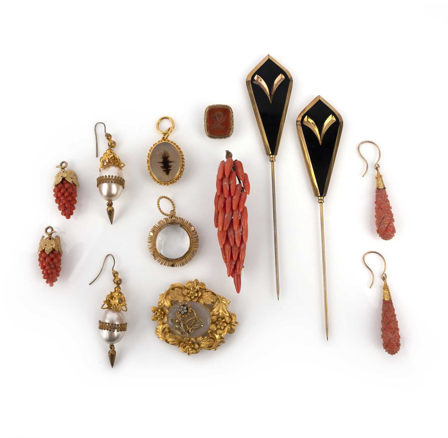 λ A group of jewels, 19th century, comprising: two pairs of carved coral drop earrings, one designed