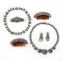 λ A suite of cut steel jewels, 19th century, comprising: a pair of hair ornaments with tortoiseshell