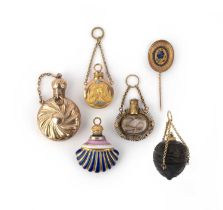 A collection of six charms, 19th century, comprising: four scent bottles, one in gold, one in gold
