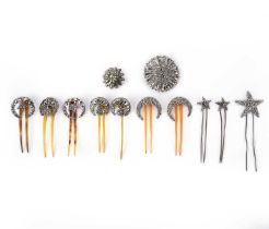 λ A group of cut steel brooches and hair pins, 19th century, comprising: ten hair pins and two