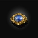 An unusual gold and sapphire ring, 19th century, set with a cabochon sapphire, within a gold mount