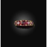 No reserve - a paste ring, circa 1903, set with five cushion-shaped red pastes, spaced by rose-cut