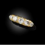 A five-stone diamond ring, set with five brilliant-cut diamonds, in a gold mount of scrolled design,