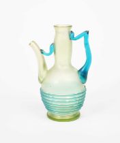 A Loetz Orpheus glass ewer, shouldered form, pale green glass body with applied blue glass handle,