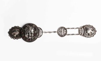 An Arts and Crafts silver cloak clasp by Charles Thomas, circular cast in relief with a Bacchanalian