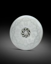 A FINE AND RARE CHINESE WHITE JADE DISC 18TH CENTURY The circular disc delicately pierced to the