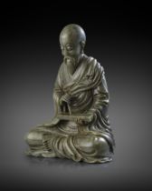 A RARE AND LARGE CHINESE SPINACH-GREEN JADE FIGURE OF A LUOHAN 18TH CENTURY Depicted seated in
