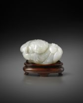 A FINE SMALL CHINESE WHITE JADE FIGURE OF A BOY 18TH CENTURY The crouching child holds a large leafy