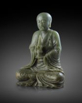 A RARE AND LARGE CHINESE SPINACH-GREEN JADE FIGURE OF A LUOHAN 18TH CENTURY Carved seated in