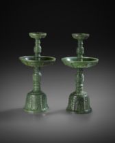 A PAIR OF FINE CHINESE SPINACH-GREEN JADE PRICKET CANDLESTICKS QIANLONG 1736-95 The bell-shaped