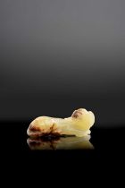 A SMALL CHINESE YELLOW JADE MODEL OF A RECUMBENT HOUND SONG/MING DYNASTY The stone is carved in