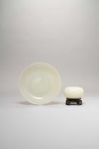 A CHINESE PALE CELADON JADE DISH AND A BOX AND COVER QIANLONG/JIANQIANG Each raised on a short