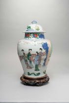 A CHINESE WUCAI BALUSTER VASE AND COVER TRANSITIONAL C.1640 Painted with ladies at leisure in a