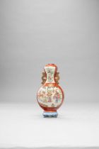 A CHINESE FAMILLE ROSE AND GILT-DECORATED WALL VASE 18TH CENTURY With twin pierced handles,