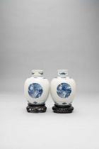 A PAIR OF CHINESE BLUE AND WHITE RIBBED OVOID JARS AND COVERS KANGXI 1662-1722 Painted with