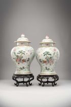 A PAIR OF CHINESE FAMILLE ROSE BALUSTER VASE AND COVERS 19TH CENTURY Painted with cartouches of