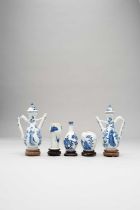 TWO CHINESE BLUE AND WHITE EWERS AND COVERS AND THREE SMALL BLUE AND WHITE VESSELS THE EWERS