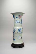 A CHINESE CELADON-GROUND 'EIGHT HORSES' GU-SHAPED VASE KANGXI 1662-1722 Decorated in slip,