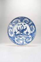 A JAPANESE BLUE AND WHITE DISH EDO PERIOD, 1670-1700 Decorated with a small bird perched on a vase