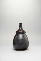 A JAPANESE BLACK-GLAZED BOTTLE VASE MEIJI OR LATER, 19TH OR 20TH CENTURY The tall high-waisted